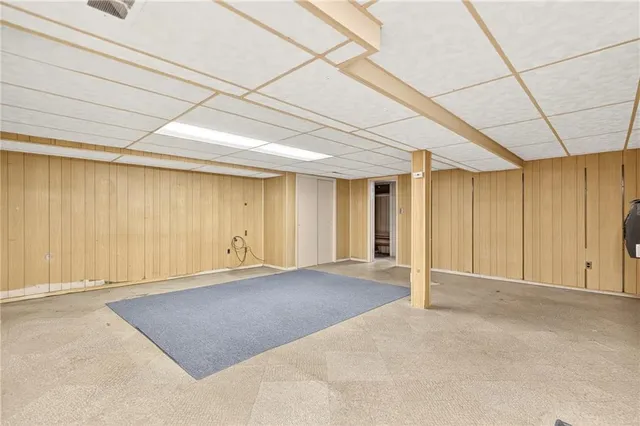 an empty room with an entrance to other room