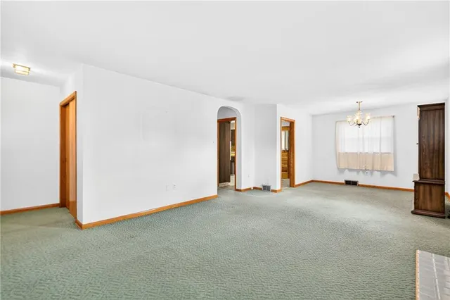 a view of an empty room with a fireplace