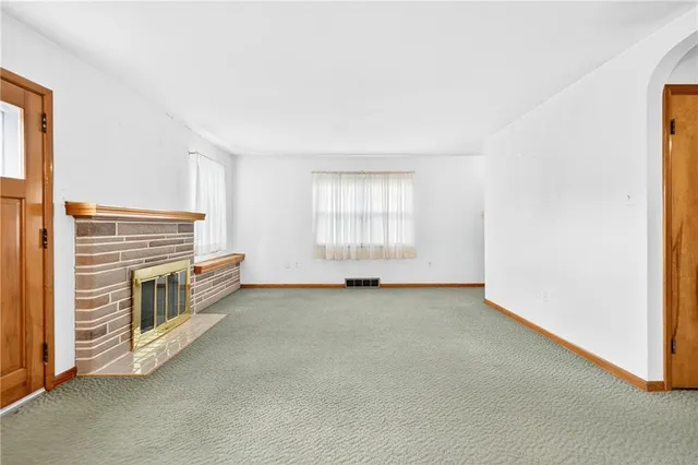 a view of an empty room with a fireplace