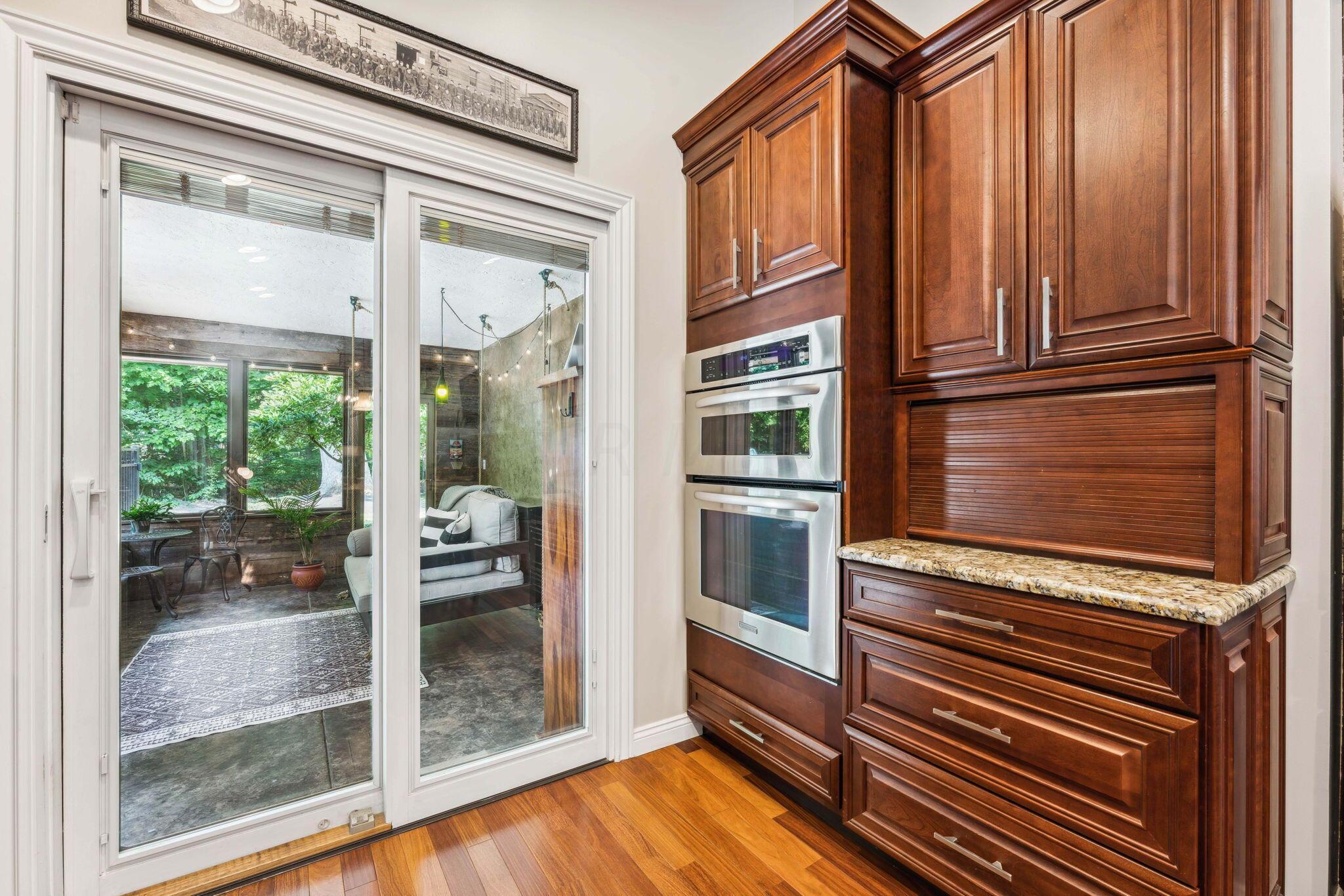 2423 Carriage Road Powell, OH 43065 - Photo 25 of 100 Sliding Glass doors lead to the cozy 3-season room!