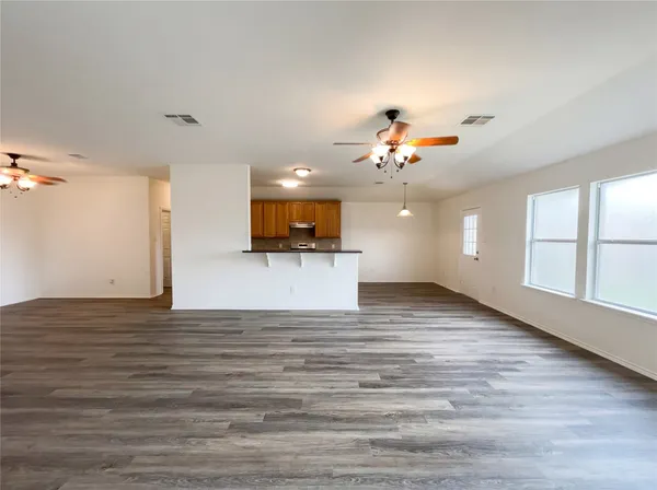 a view of a kitchen with a microwave and a ceiling fan