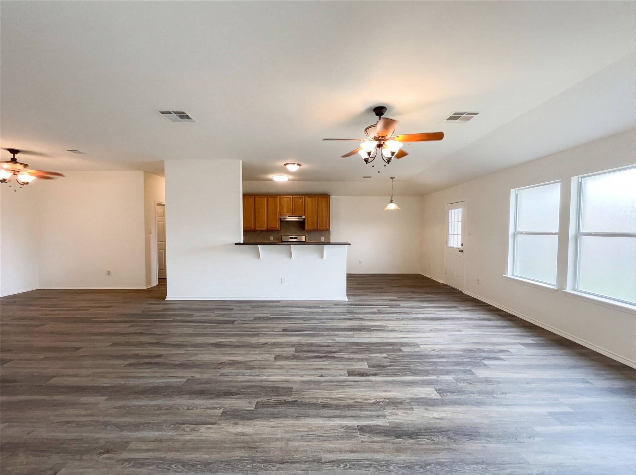 506 Gettysburg Loop Elgin, TX 78621 - Photo 15 of 39 a view of a kitchen with a microwave and a ceiling fan