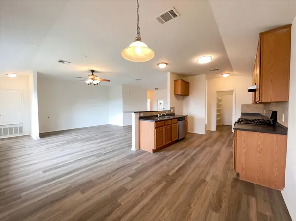 a view of kitchen with sink and wooden floor