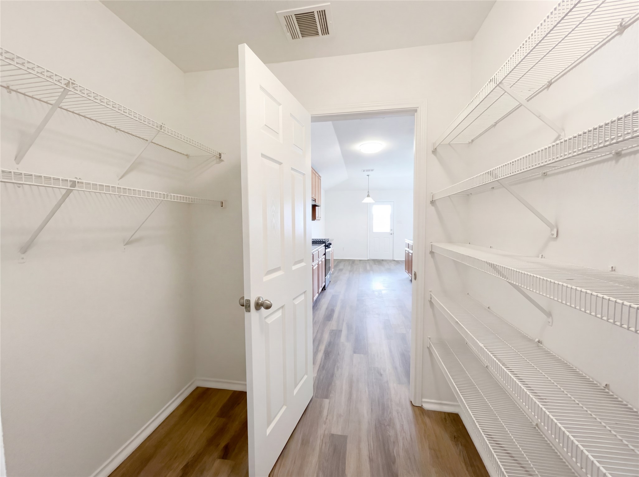 506 Gettysburg Loop Elgin, TX 78621 - Photo 23 of 39 a view of a hallway with wooden floor and staircase