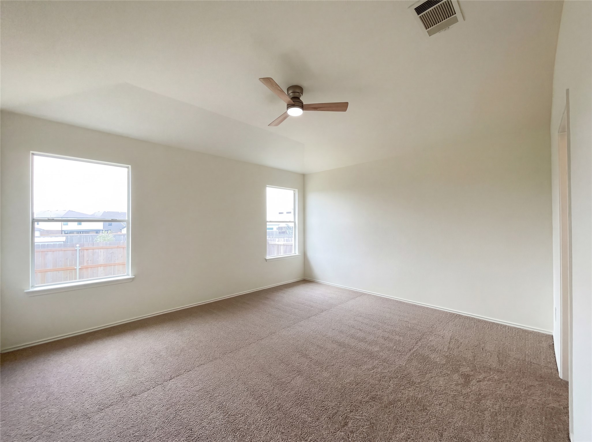 506 Gettysburg Loop Elgin, TX 78621 - Photo 25 of 39 an empty room with a window and a ceiling fan