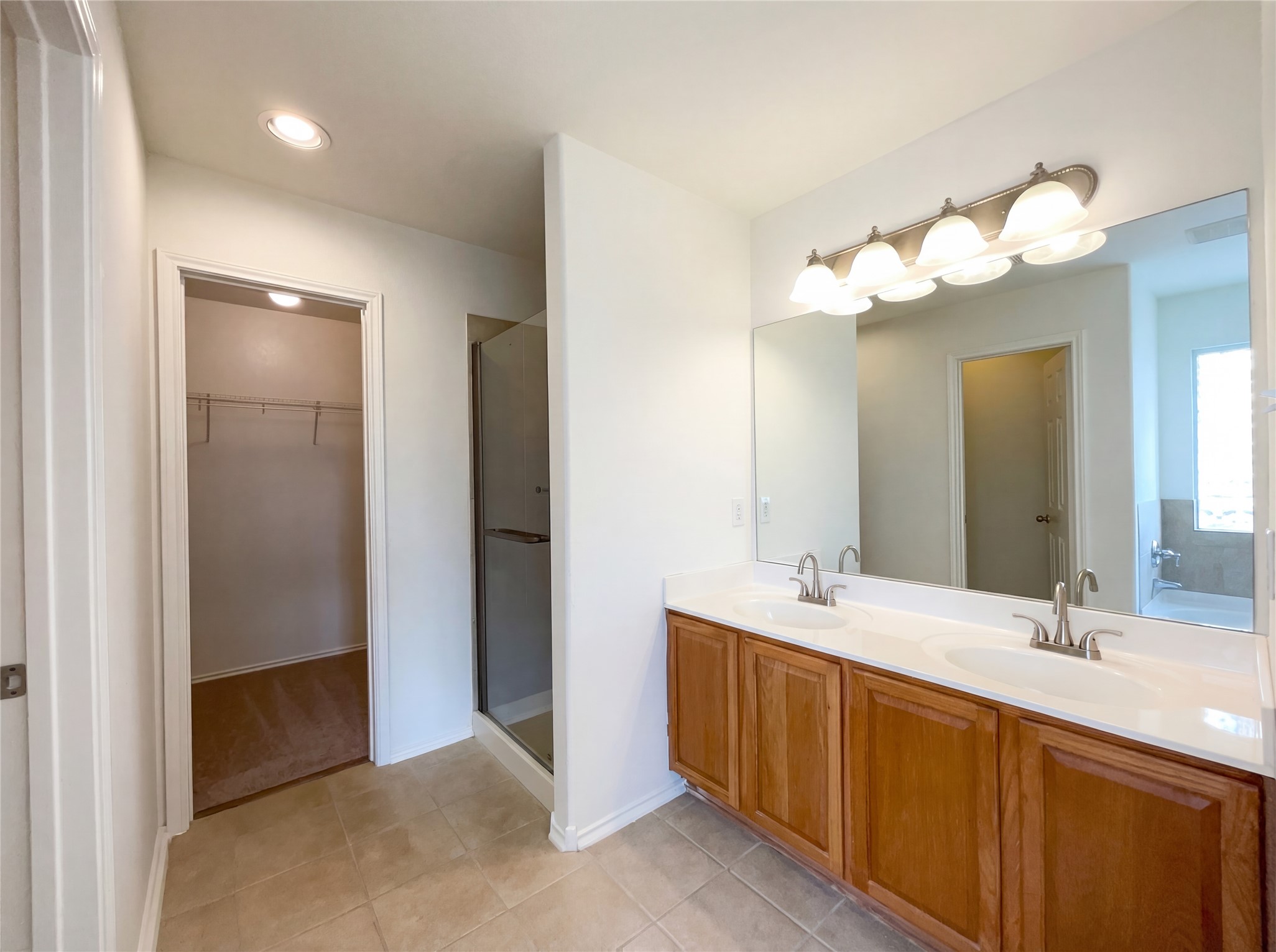 506 Gettysburg Loop Elgin, TX 78621 - Photo 27 of 39 a bathroom with a double vanity sink and a mirror