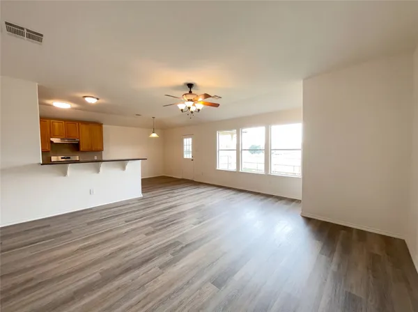 a view of a kitchen with a microwave and a window
