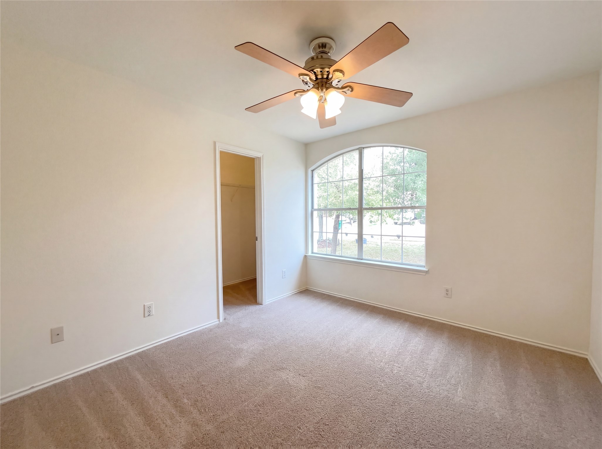 506 Gettysburg Loop Elgin, TX 78621 - Photo 33 of 39 an empty room with windows and fan
