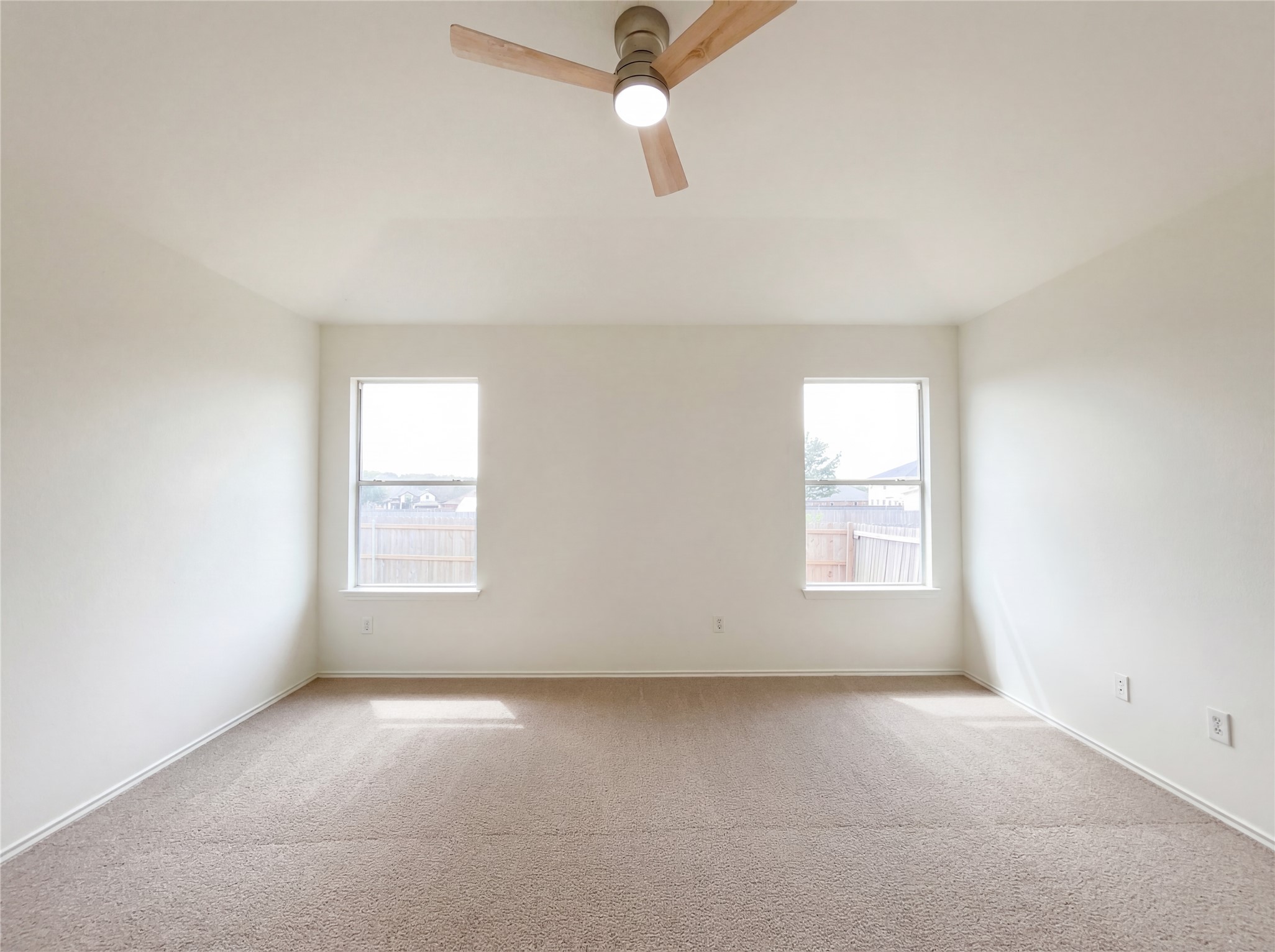 506 Gettysburg Loop Elgin, TX 78621 - Photo 4 of 39 an empty room with windows and fan
