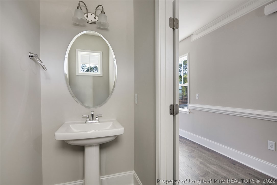 416 Kerr Lake Road Aberdeen, NC 28315 - Photo 7 of 45 a bathroom with a sink a mirror and shower