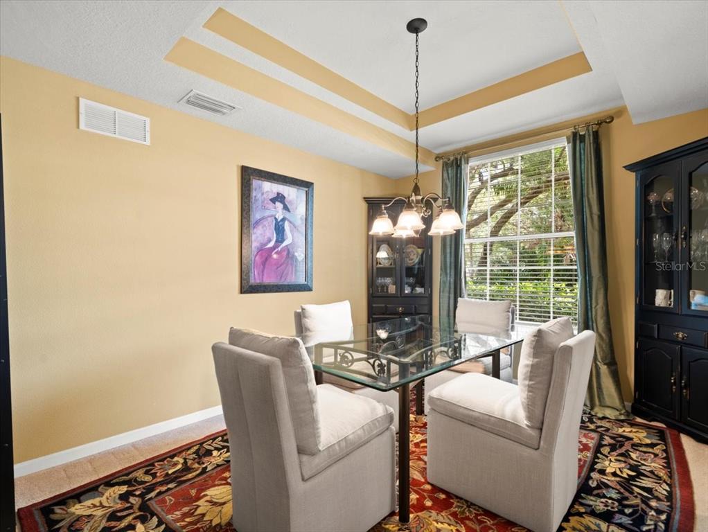 897 Lantern Way Clearwater, FL 33765 - Photo 11 of 56 a dining room with furniture a chandelier and window