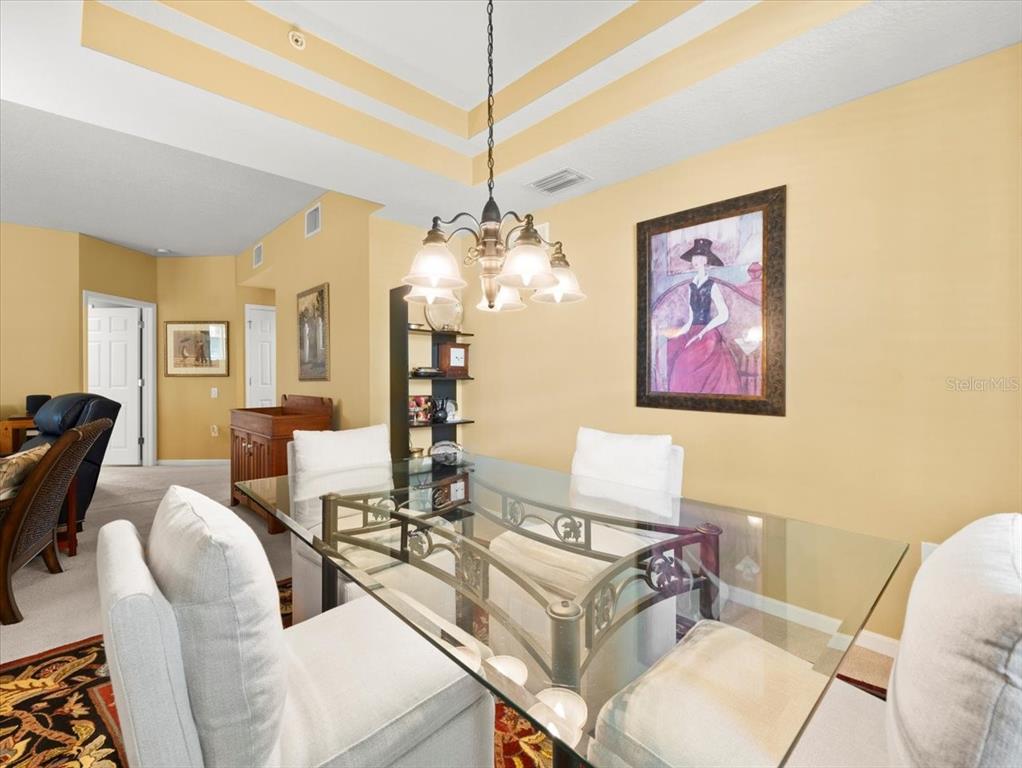 897 Lantern Way Clearwater, FL 33765 - Photo 12 of 56 a living room with furniture and a chandelier