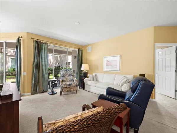 a living room with furniture and a lamp