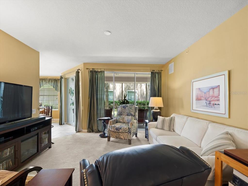 897 Lantern Way Clearwater, FL 33765 - Photo 15 of 56 a living room with furniture and a flat screen tv