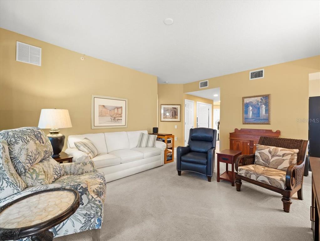 897 Lantern Way Clearwater, FL 33765 - Photo 17 of 56 a living room with furniture and a lamp