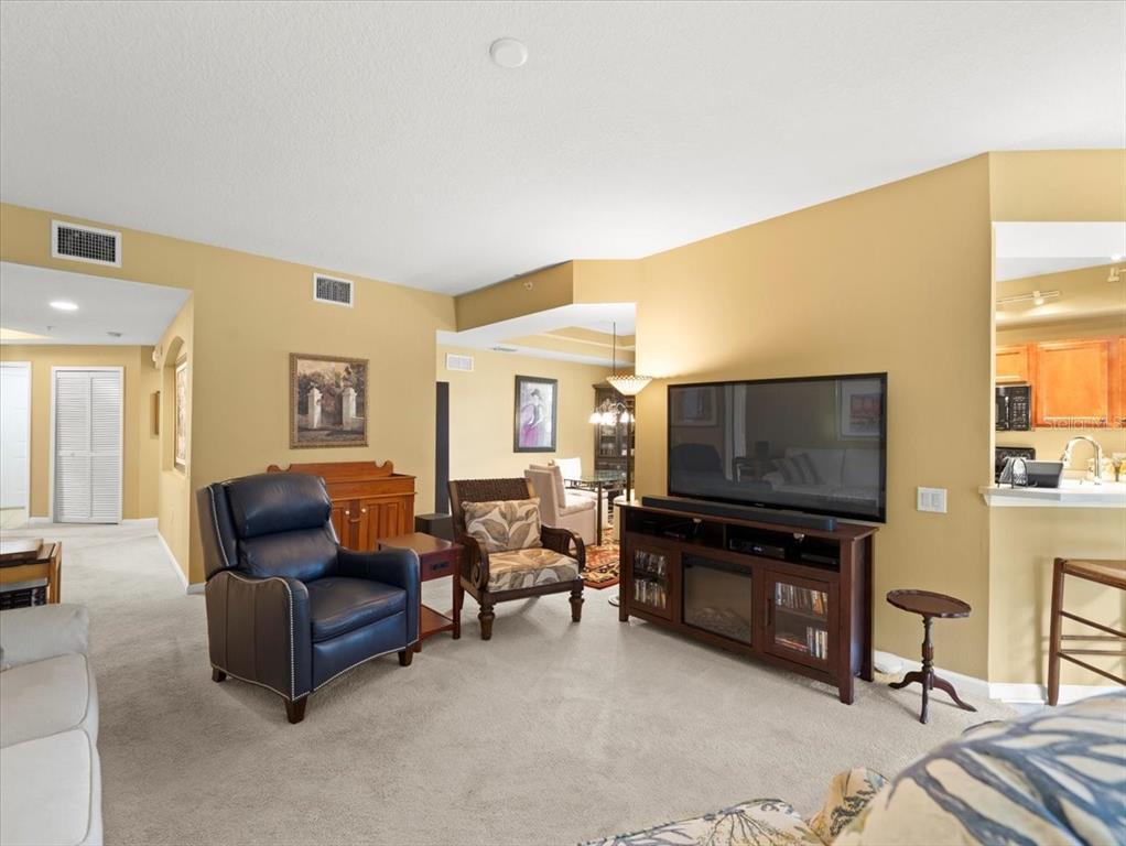 897 Lantern Way Clearwater, FL 33765 - Photo 18 of 56 a living room with furniture and a flat screen tv