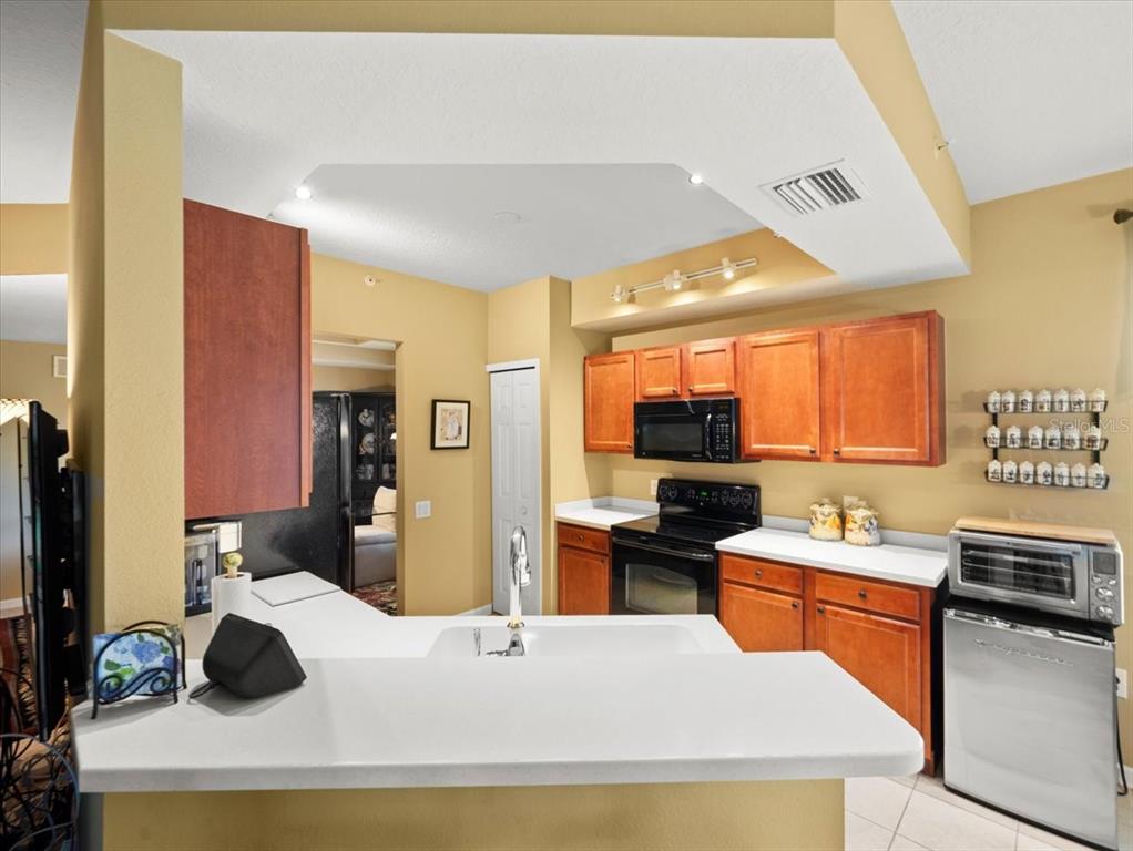 897 Lantern Way Clearwater, FL 33765 - Photo 19 of 56 a kitchen that has a sink and a stove in it