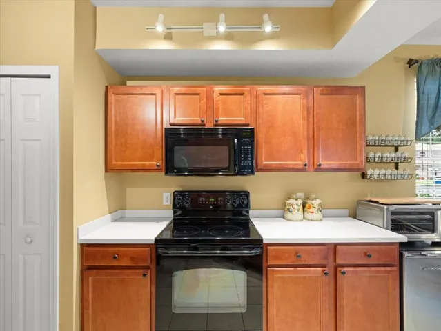 a kitchen with a stove a sink and a microwave