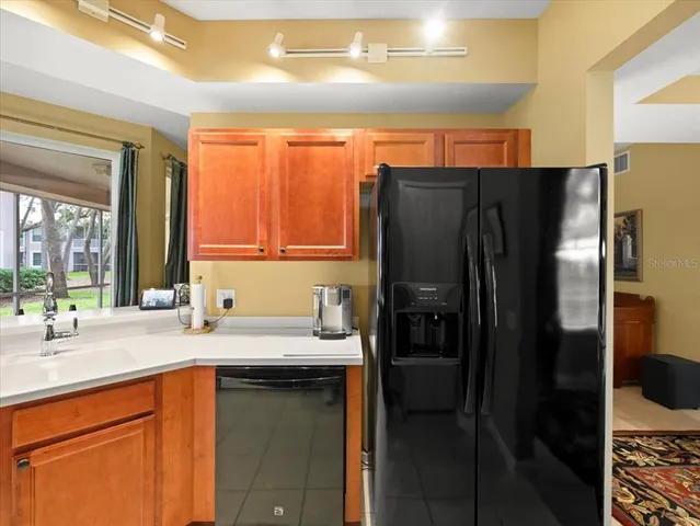 a kitchen with stainless steel appliances a stove microwave and sink