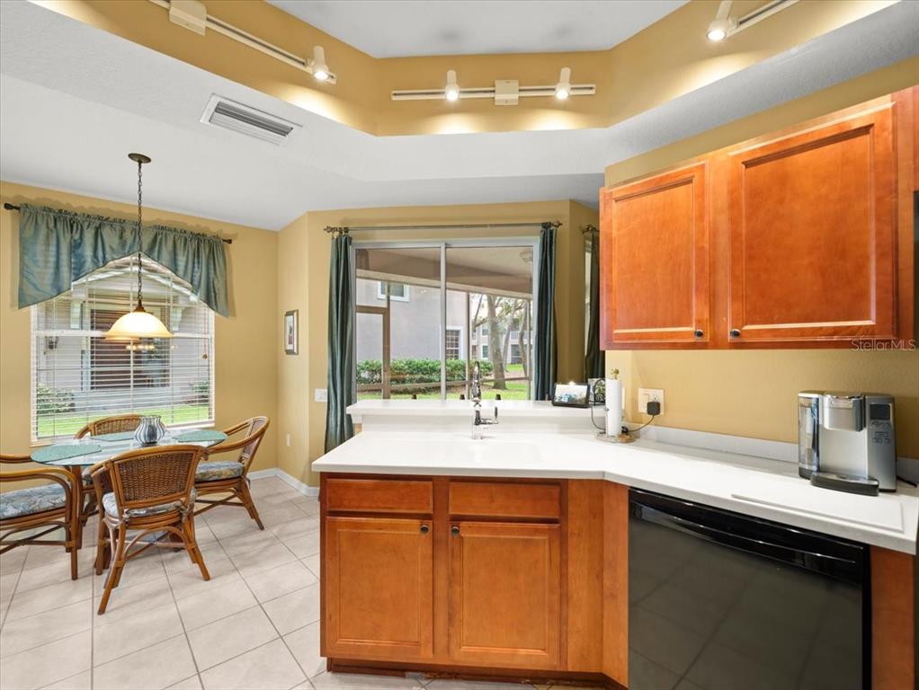 897 Lantern Way Clearwater, FL 33765 - Photo 23 of 56 a kitchen with a sink and a wooden cabinets