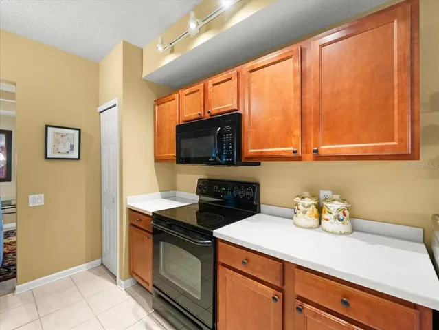 a dining room with furniture and large windows