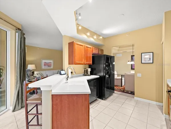 a living room with furniture a rug and kitchen view