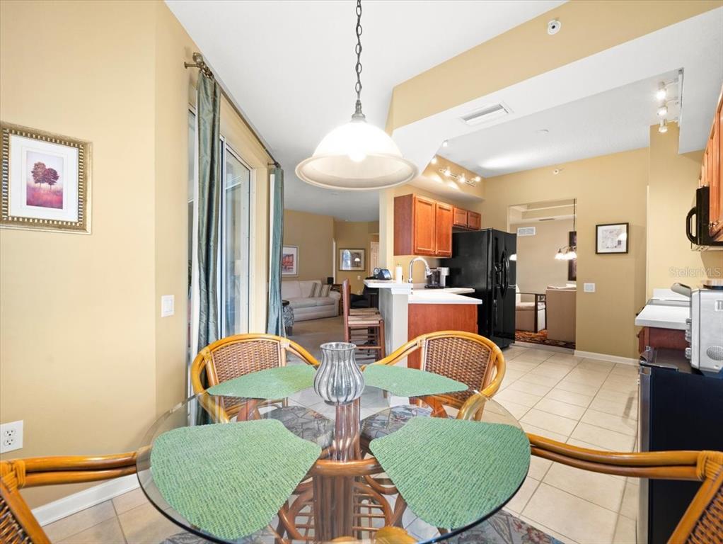 897 Lantern Way Clearwater, FL 33765 - Photo 29 of 56 a living room with furniture a rug and kitchen view