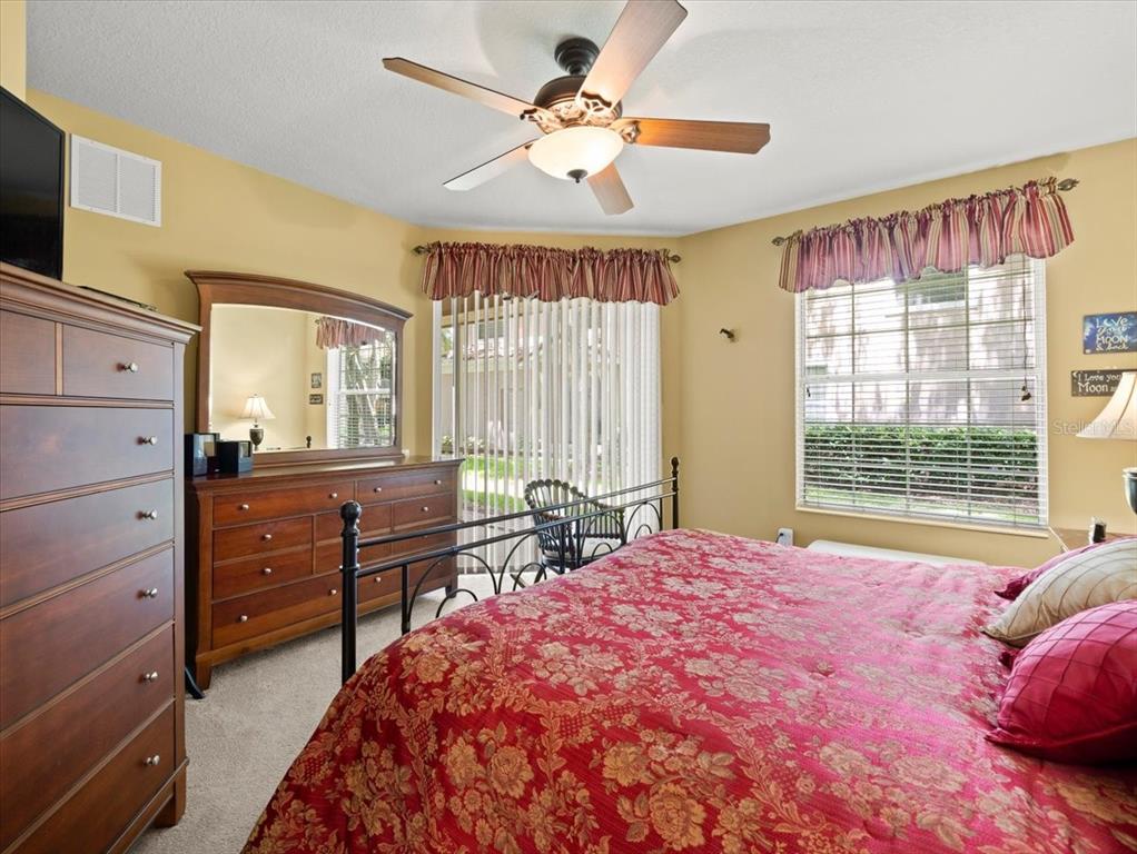 897 Lantern Way Clearwater, FL 33765 - Photo 32 of 56 a bedroom with a bed dresser and a window