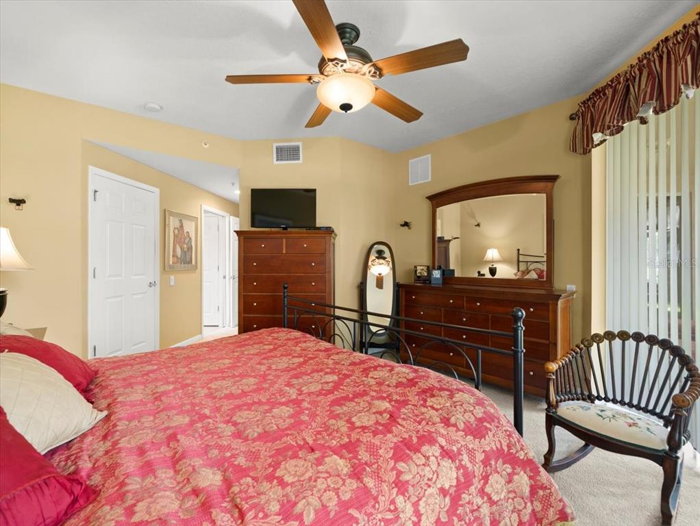 897 Lantern Way Clearwater, FL 33765 - Photo 33 of 56 a bedroom with a bed and a dresser in it