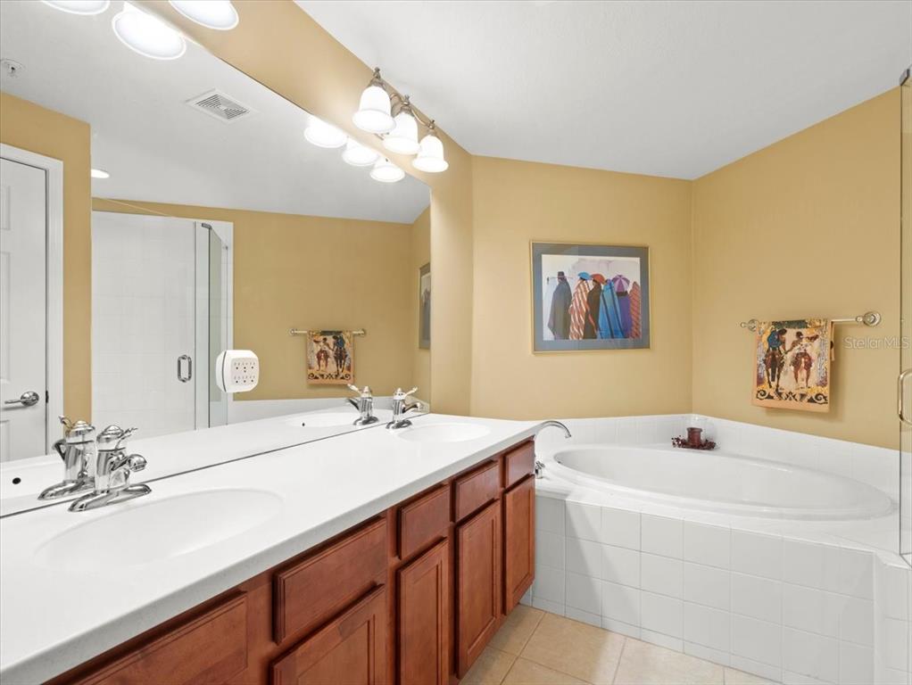 897 Lantern Way Clearwater, FL 33765 - Photo 35 of 56 a bathroom with a tub double sink and mirror