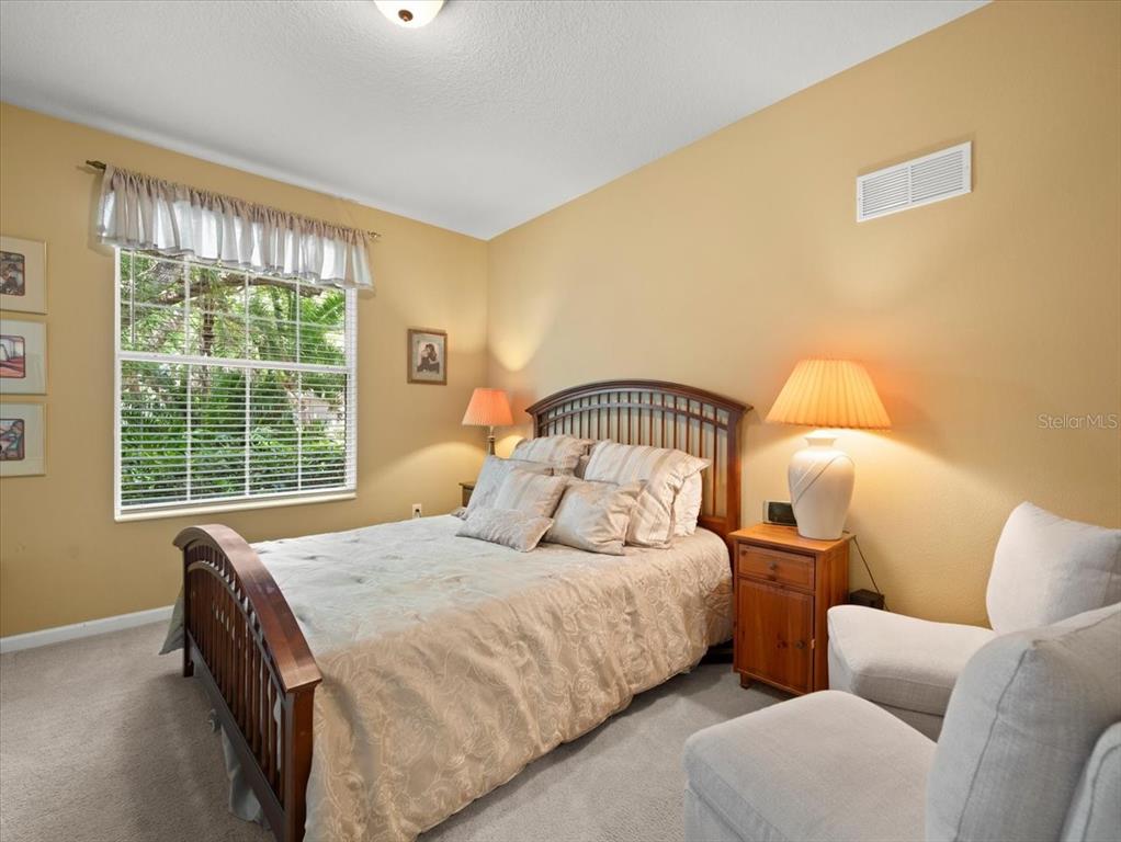 897 Lantern Way Clearwater, FL 33765 - Photo 38 of 56 a bedroom with a bed couch and window