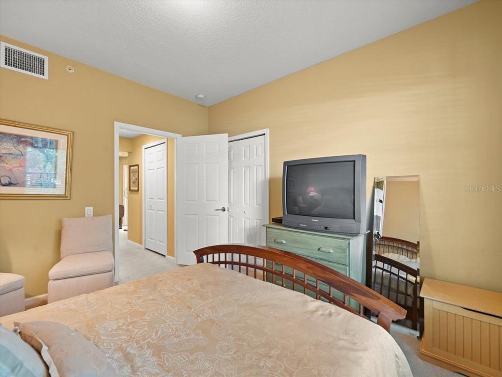 897 Lantern Way Clearwater, FL 33765 - Photo 39 of 56 a bedroom with a bed and a flat screen tv