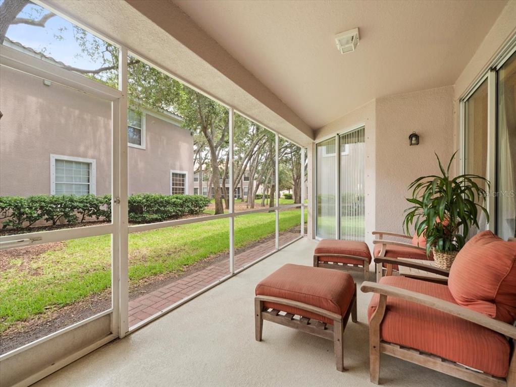 897 Lantern Way Clearwater, FL 33765 - Photo 43 of 56 a living room with furniture and a floor to ceiling window