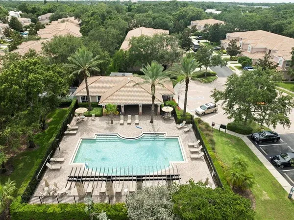 an aerial view of a house with a yard and lake view