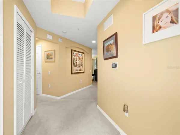 a living room with furniture a chandelier and a large window