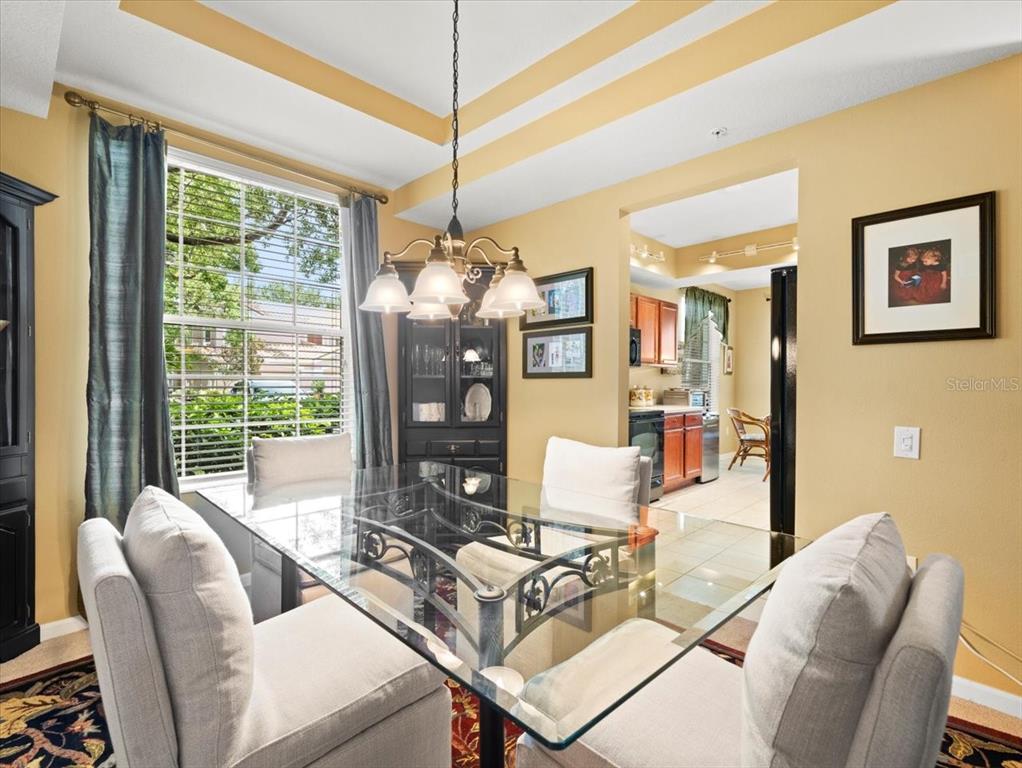 897 Lantern Way Clearwater, FL 33765 - Photo 10 of 56 a living room with furniture a chandelier and a large window