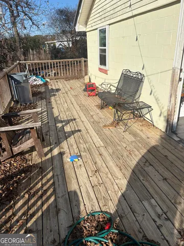 a view of a patio with table and chairs with wooden floor