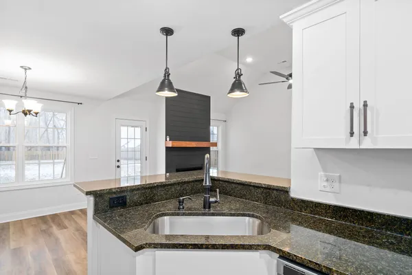 a kitchen with a refrigerator and a sink
