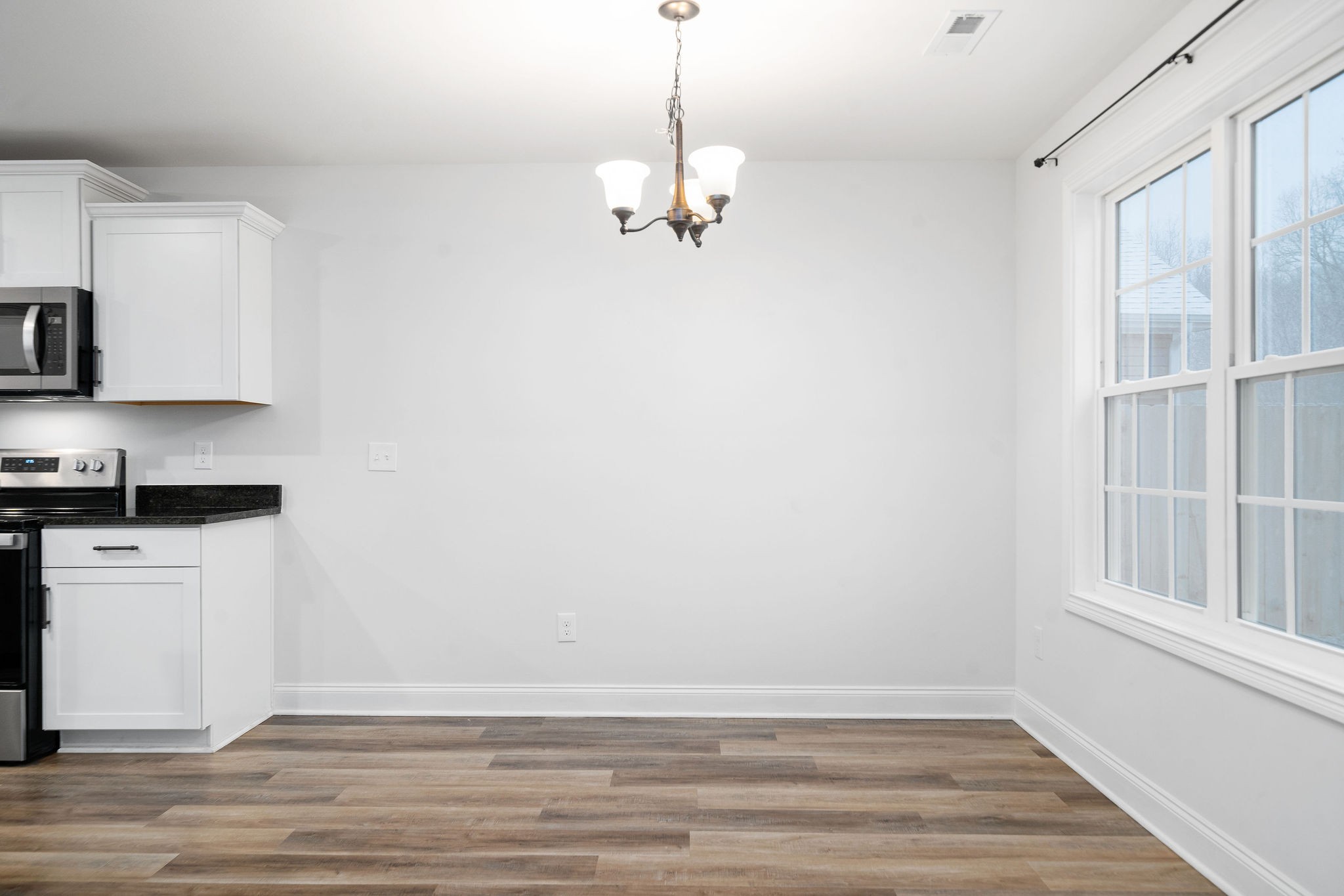 472 Hawkins Road Clarksville, TN 37040 - Photo 16 of 33 a view of a kitchen with a dishwasher cabinets and a wooden floor