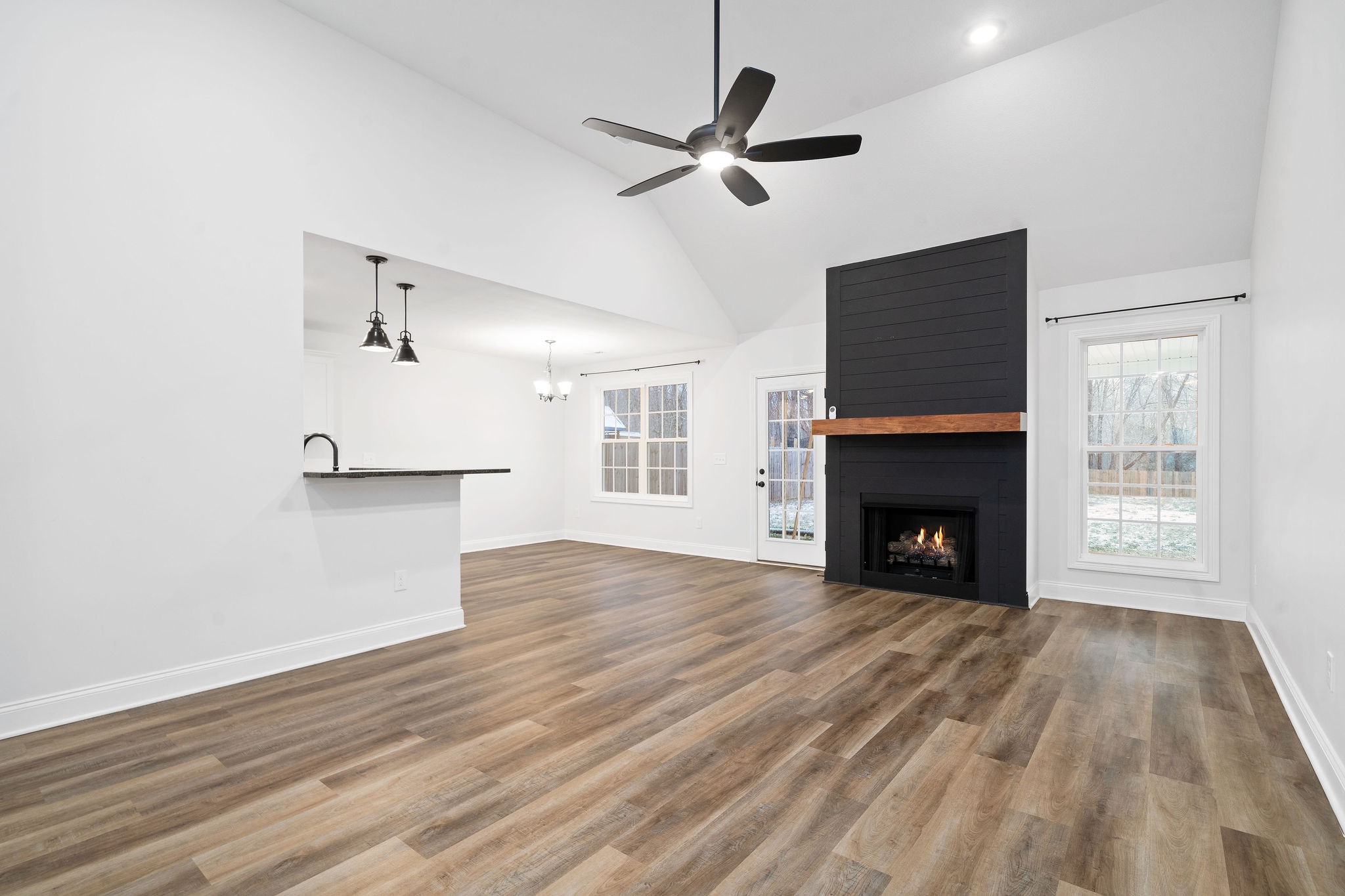 472 Hawkins Road Clarksville, TN 37040 - Photo 6 of 33 a view of empty room with wooden floor fireplace and a window