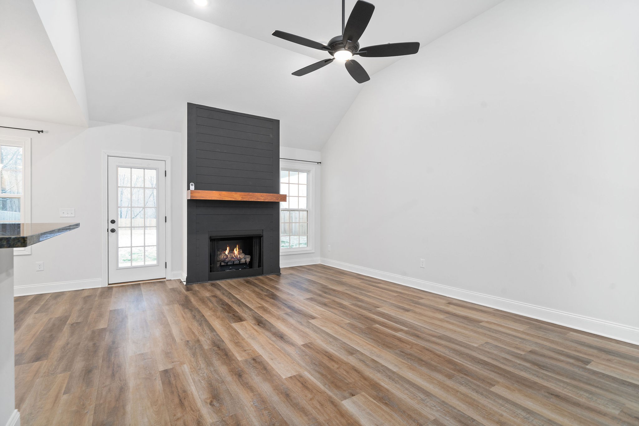 472 Hawkins Road Clarksville, TN 37040 - Photo 8 of 33 a view of an empty room with wooden floor fireplace and a window