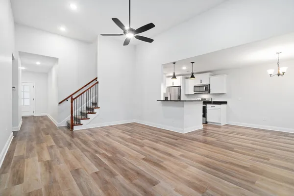 a view of kitchen with cabinets appliances and wooden floor