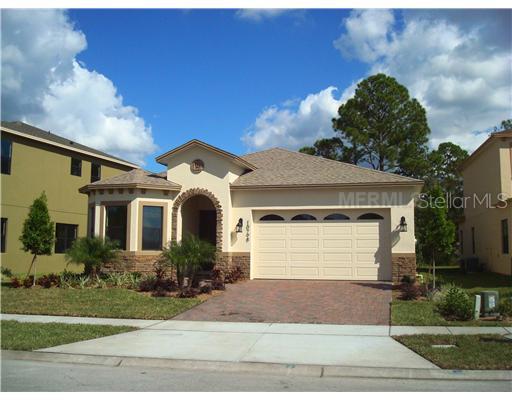 10798 Willow Ridge Loop Orlando, FL 32825 - Photo 1 of 1 a front view of a house with a yard and garage