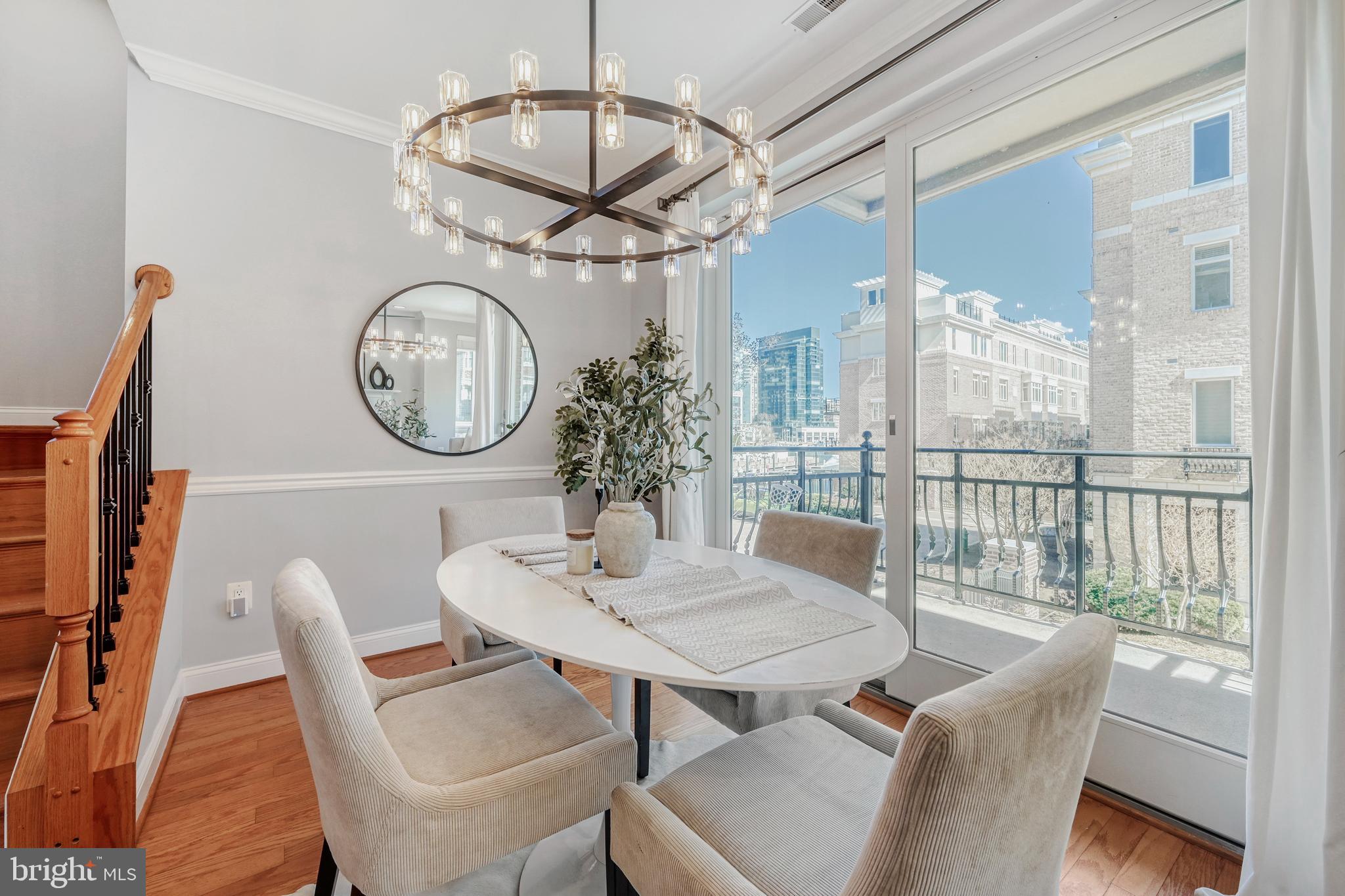 900 Valencia Court, Unit 188 Baltimore, MD 21230 - Photo 15 of 46 a view of a dining room with furniture a chandelier and wooden floor