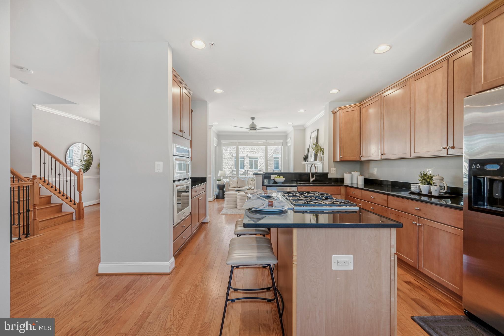 900 Valencia Court, Unit 188 Baltimore, MD 21230 - Photo 19 of 46 a kitchen with stainless steel appliances granite countertop a stove a sink dishwasher and a refrigerator with wooden floor