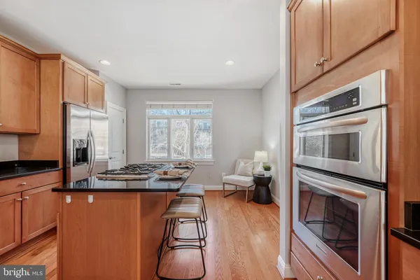 a kitchen with stainless steel appliances a stove sink and microwave