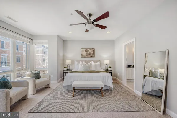 a spacious bedroom with a bed and window