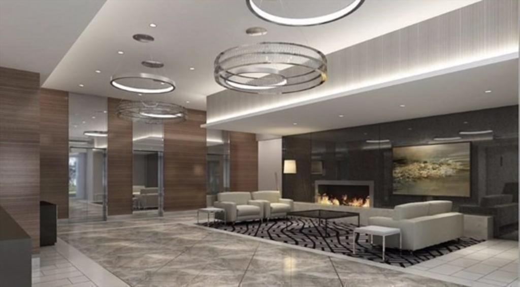 151 Tremont Street, Unit 9S Boston, MA 02111 - Photo 2 of 11 a living room with furniture and a fireplace