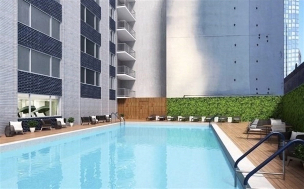 151 Tremont Street, Unit 9S Boston, MA 02111 - Photo 5 of 11 a front view of a house with a yard