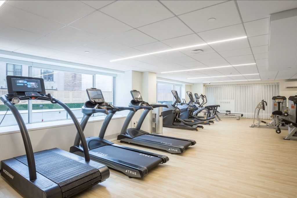 151 Tremont Street, Unit 9S Boston, MA 02111 - Photo 8 of 11 a view of a room with gym equipment